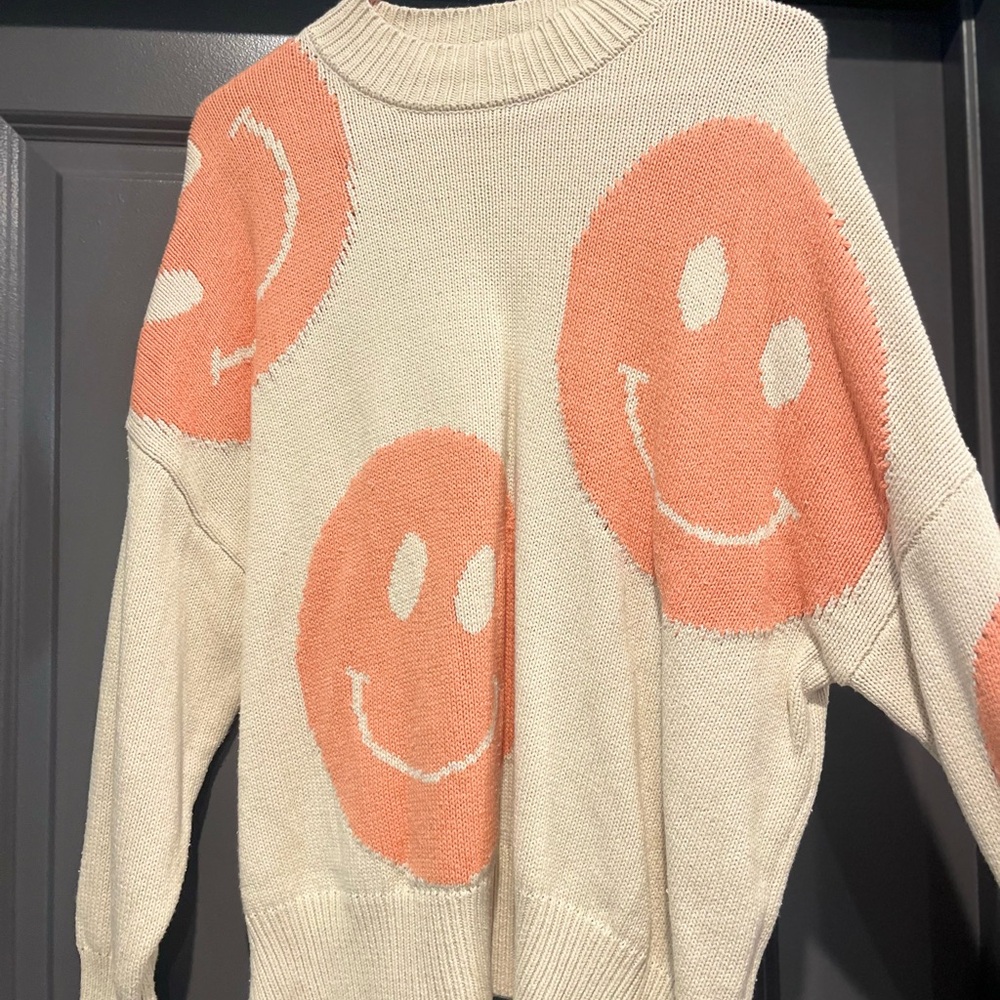Smiley Face Cream and Orange Sweater